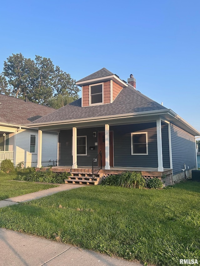 2016 Chestnut St, Quincy, IL 62301 - view of front facade featuring a shingled roof, a chimney, a front yard, and covered porch