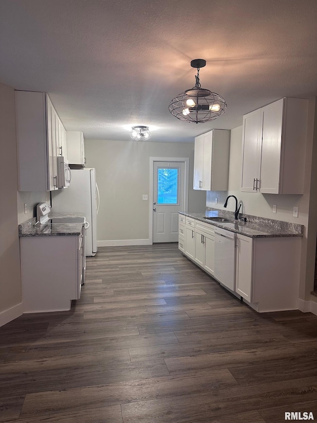 2016 Chestnut St, Quincy, IL 62301 - kitchen featuring dishwasher, stainless steel microwave, dark wood-style floors, white cabinets, and a textured ceiling