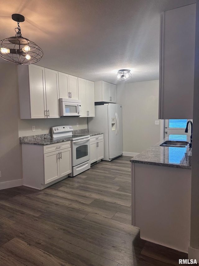 2016 Chestnut St, Quincy, IL 62301 - kitchen featuring white appliances, dark wood-style floors, white cabinetry, and dark stone counters