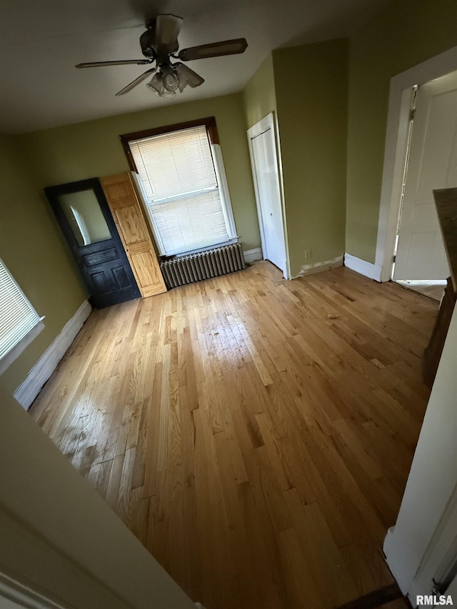 342 W Reynolds St, Springfield, IL 62702 - unfurnished living room featuring radiator, hardwood / wood-style floors, and a ceiling fan