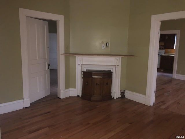342 W Reynolds St, Springfield, IL 62702 - unfurnished living room featuring wood finished floors and a fireplace