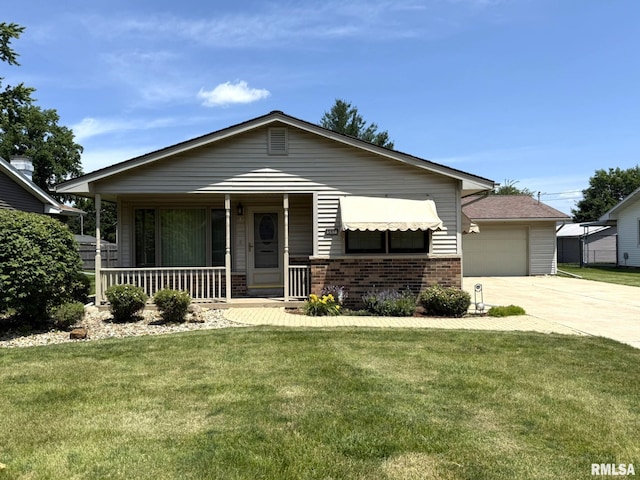 597 Walnut St, Knoxville, IL 61448 - view of front of property featuring covered porch, brick siding, concrete driveway, a front yard, and a garage