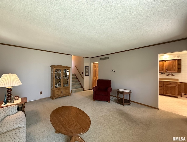 597 Walnut St, Knoxville, IL 61448 - living room with crown molding, stairway, light colored carpet, and a textured ceiling