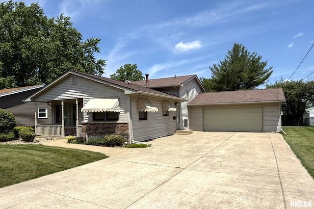 597 Walnut St, Knoxville, IL 61448 - view of front of home with a front lawn, concrete driveway, covered porch, an attached garage, and brick siding
