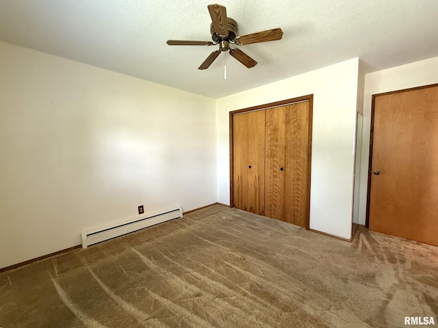597 Walnut St, Knoxville, IL 61448 - unfurnished bedroom with a baseboard radiator, carpet floors, a ceiling fan, and a closet