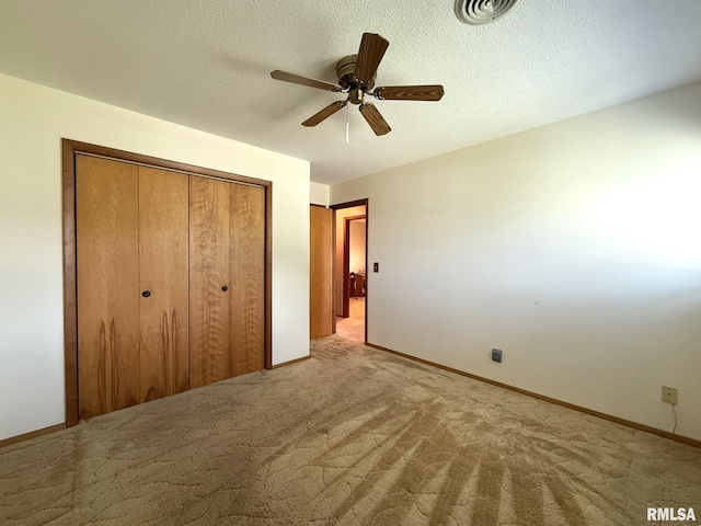 597 Walnut St, Knoxville, IL 61448 - unfurnished bedroom with a closet, carpet flooring, a ceiling fan, and a textured ceiling