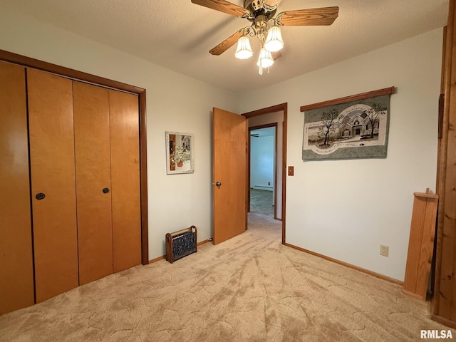 597 Walnut St, Knoxville, IL 61448 - unfurnished bedroom featuring light carpet, a closet, and a ceiling fan