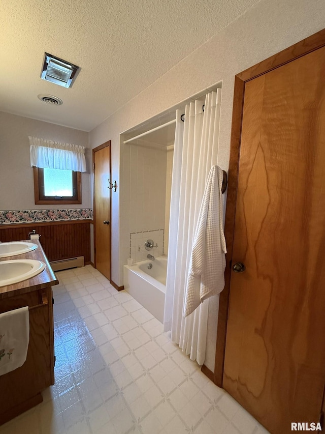 597 Walnut St, Knoxville, IL 61448 - bathroom with double vanity, tile patterned floors, baseboard heating, a textured ceiling, and bathtub / shower combination