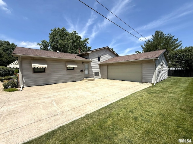 597 Walnut St, Knoxville, IL 61448 - tri-level home with a front yard, concrete driveway, and an attached garage