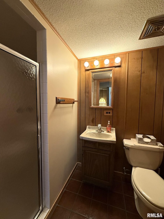 597 Walnut St, Knoxville, IL 61448 - full bath featuring a textured ceiling, vanity, a shower stall, and tile patterned flooring