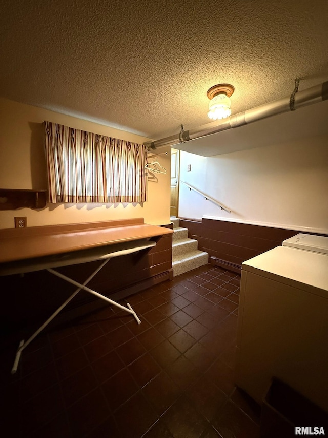 597 Walnut St, Knoxville, IL 61448 - laundry room featuring washer / clothes dryer, a textured ceiling, and dark tile patterned flooring