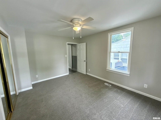 2015 N 19th St, Springfield, IL 62702 - unfurnished bedroom with dark carpet and a ceiling fan