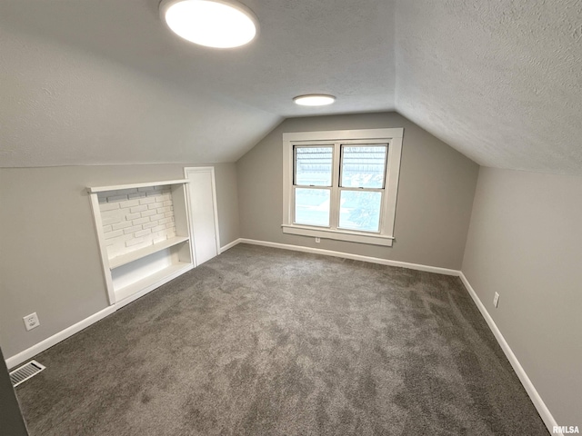 2015 N 19th St, Springfield, IL 62702 - bonus room featuring a textured ceiling, lofted ceiling, carpet, and built in features