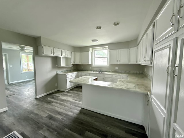 2015 N 19th St, Springfield, IL 62702 - kitchen with a peninsula, white cabinets, and plenty of natural light