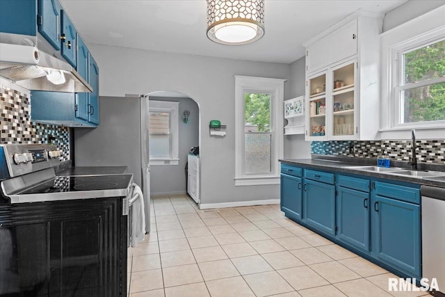 826 S Douglas Ave, Springfield, IL 62704 - kitchen featuring blue cabinetry, appliances with stainless steel finishes, under cabinet range hood, and arched walkways