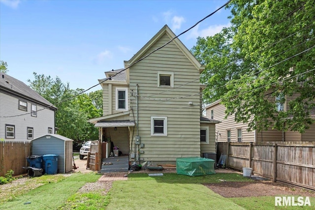 826 S Douglas Ave, Springfield, IL 62704 - rear view of house featuring a fenced backyard and a storage shed