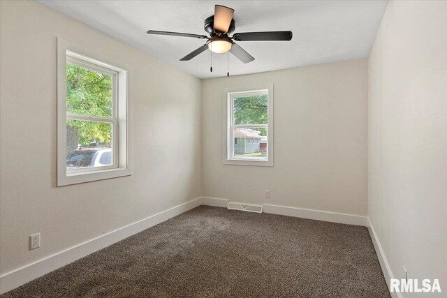 707 N Adams St, Lincoln, IL 62656 - spare room featuring dark carpet and ceiling fan