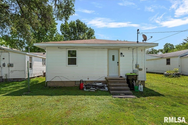 707 N Adams St, Lincoln, IL 62656 - back of property featuring a lawn