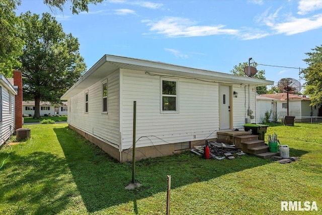 707 N Adams St, Lincoln, IL 62656 - back of property featuring a lawn