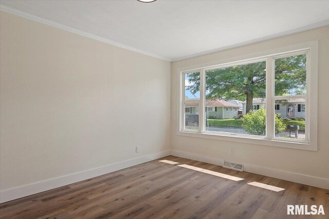 707 N Adams St, Lincoln, IL 62656 - empty room featuring crown molding and wood finished floors