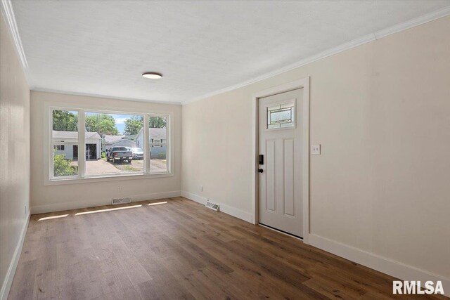 707 N Adams St, Lincoln, IL 62656 - entryway with ornamental molding, healthy amount of natural light, and wood finished floors