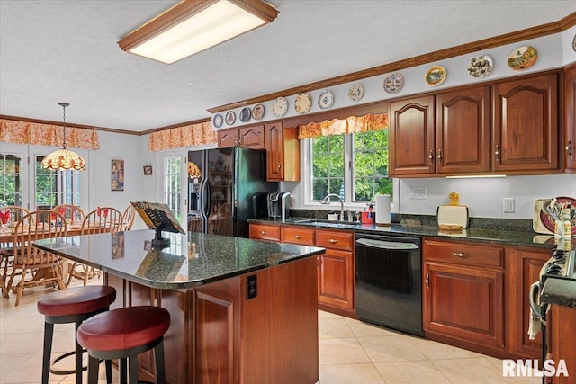 828 Coventry Pt, Springfield, IL 62702 - kitchen featuring black appliances, a textured ceiling, light tile patterned floors, a breakfast bar, and a center island