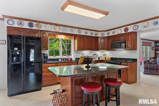 828 Coventry Pt, Springfield, IL 62702 - kitchen with black appliances, a kitchen island, light tile patterned floors, healthy amount of natural light, and crown molding