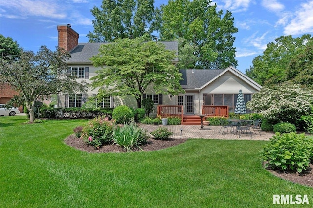 828 Coventry Pt, Springfield, IL 62702 - rear view of house with a patio, a wooden deck, a chimney, a lawn, and a shingled roof