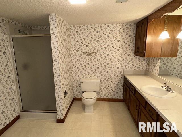 2524 Greenbriar Rd, Springfield, IL 62704 - full bath featuring vanity, wallpapered walls, a shower stall, and a textured ceiling
