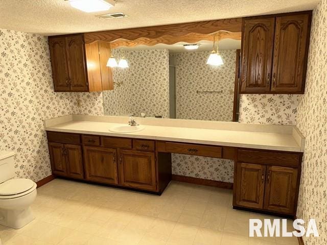 2524 Greenbriar Rd, Springfield, IL 62704 - bathroom with vanity, wallpapered walls, and a textured ceiling