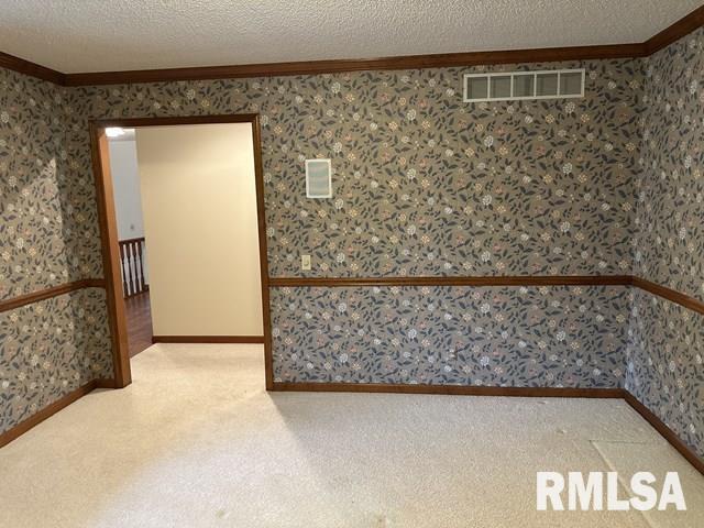 2524 Greenbriar Rd, Springfield, IL 62704 - unfurnished room with crown molding, carpet, a textured ceiling, and wallpapered walls