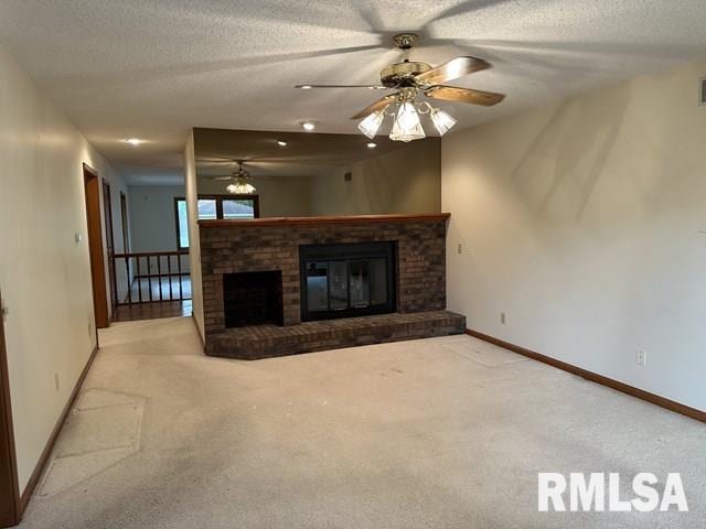 2524 Greenbriar Rd, Springfield, IL 62704 - unfurnished living room featuring a ceiling fan, carpet floors, a brick fireplace, and a textured ceiling