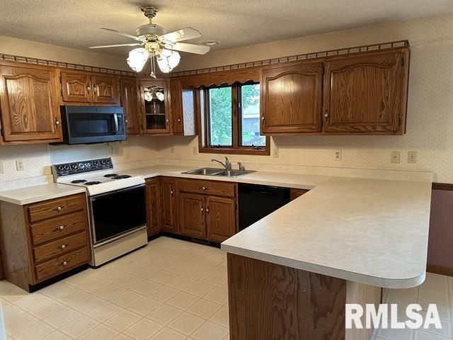 2524 Greenbriar Rd, Springfield, IL 62704 - kitchen featuring electric range, a peninsula, black dishwasher, light countertops, and wallpapered walls