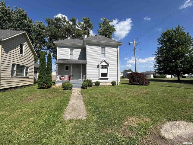 120 S Walnut St, Assumption, IL 62510 - traditional-style house featuring a porch, a front lawn, and a shingled roof