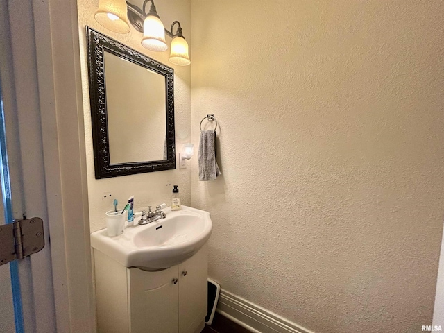 120 S Walnut St, Assumption, IL 62510 - bathroom featuring vanity and a textured wall