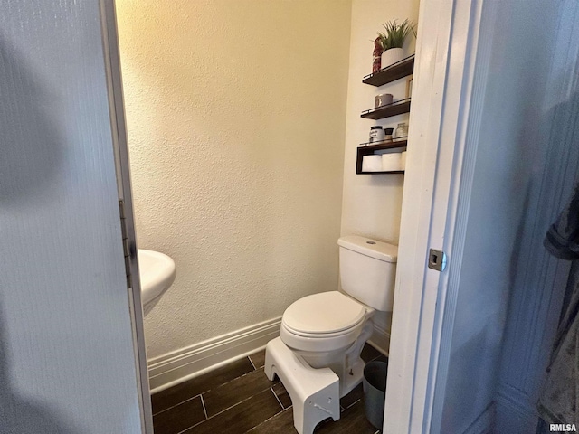 120 S Walnut St, Assumption, IL 62510 - bathroom featuring baseboards and wood tiled floors