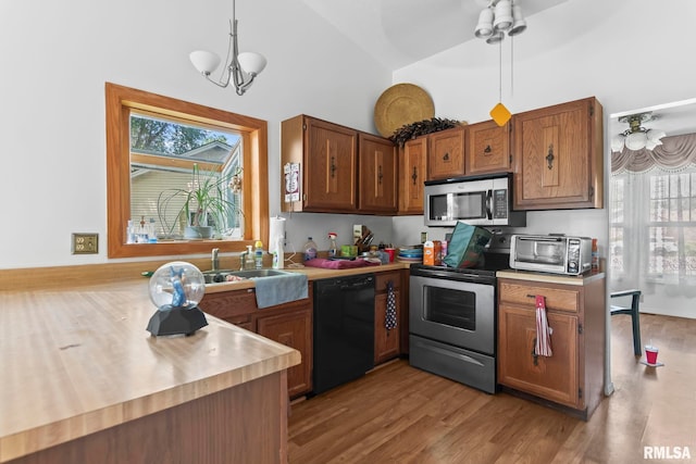 2924 Flowerbrook Ct, Springfield, IL 62702 - kitchen featuring stainless steel appliances, high vaulted ceiling, light countertops, plenty of natural light, and wood finished floors