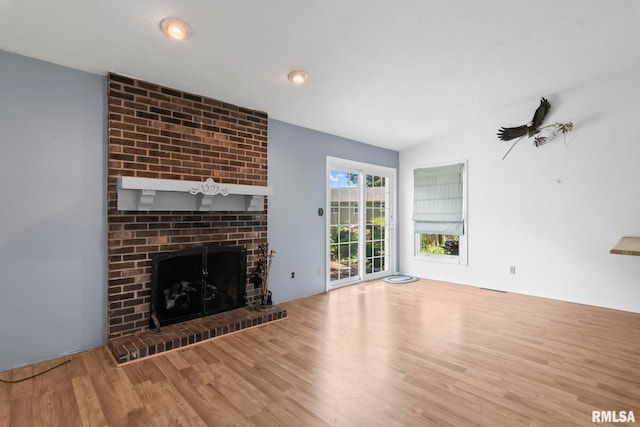 2924 Flowerbrook Ct, Springfield, IL 62702 - unfurnished living room with wood finished floors, a brick fireplace, and lofted ceiling
