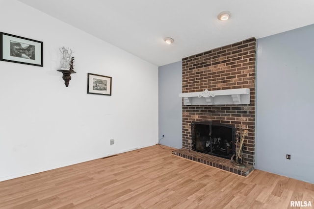 2924 Flowerbrook Ct, Springfield, IL 62702 - unfurnished living room featuring wood finished floors and a brick fireplace