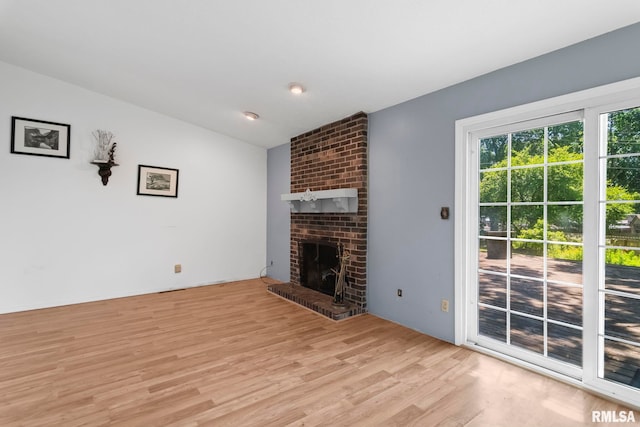 2924 Flowerbrook Ct, Springfield, IL 62702 - unfurnished living room featuring vaulted ceiling, light wood finished floors, and a fireplace