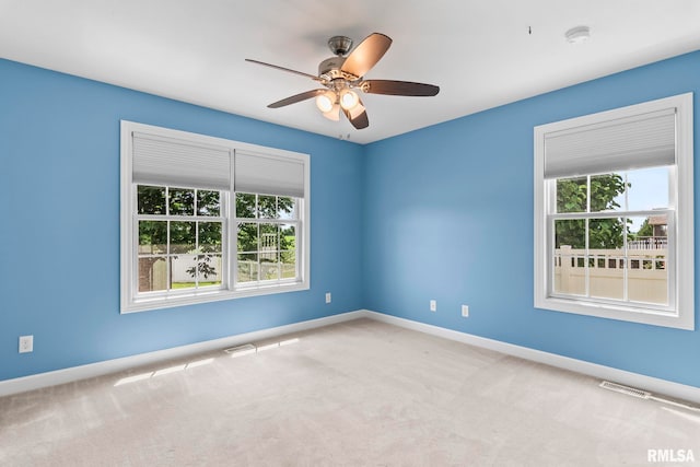 401 Cherry Cir, Williamsville, IL 62693 - carpeted spare room featuring healthy amount of natural light, a ceiling fan, and a smoke detector