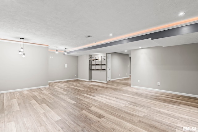 401 Cherry Cir, Williamsville, IL 62693 - unfurnished living room featuring light wood-type flooring, a textured ceiling, and recessed lighting