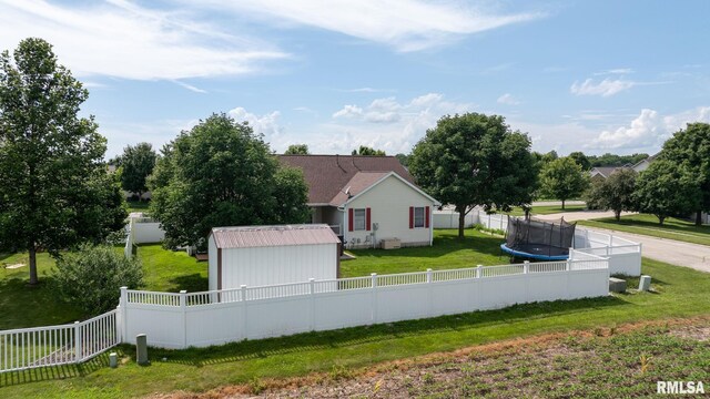 401 Cherry Cir, Williamsville, IL 62693 - view of front of property with a fenced backyard, a trampoline, and a storage unit