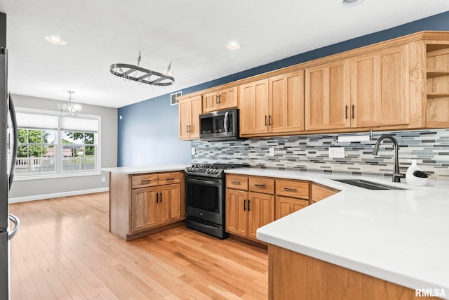 401 Cherry Cir, Williamsville, IL 62693 - kitchen featuring stainless steel appliances, a peninsula, light countertops, decorative backsplash, and recessed lighting
