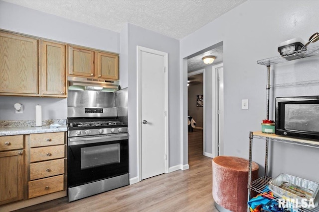 2900 Taylor Ave Unit 2, Springfield, IL 62703 - kitchen featuring stainless steel gas range, under cabinet range hood, light wood-style floors, a textured ceiling, and light brown cabinetry