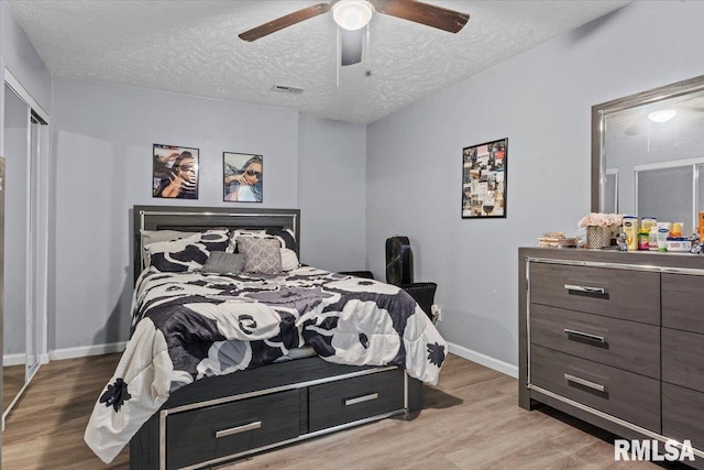 2900 Taylor Ave Unit 2, Springfield, IL 62703 - bedroom with light wood-type flooring, a textured ceiling, and a ceiling fan