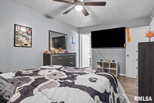 2900 Taylor Ave Unit 2, Springfield, IL 62703 - bedroom with wood finished floors, a textured ceiling, and a ceiling fan