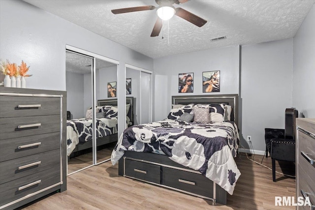 2900 Taylor Ave Unit 2, Springfield, IL 62703 - bedroom with two closets, a textured ceiling, wood finished floors, and ceiling fan