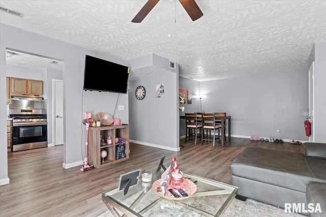 2900 Taylor Ave Unit 2, Springfield, IL 62703 - living room featuring a ceiling fan, wood finished floors, and a textured ceiling