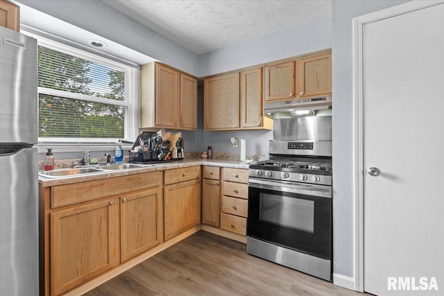 2900 Taylor Ave Unit 2, Springfield, IL 62703 - kitchen with appliances with stainless steel finishes, under cabinet range hood, wood finished floors, a textured ceiling, and light countertops